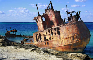 sunken abandoned ship off the beaches of Bimini in crystal waters